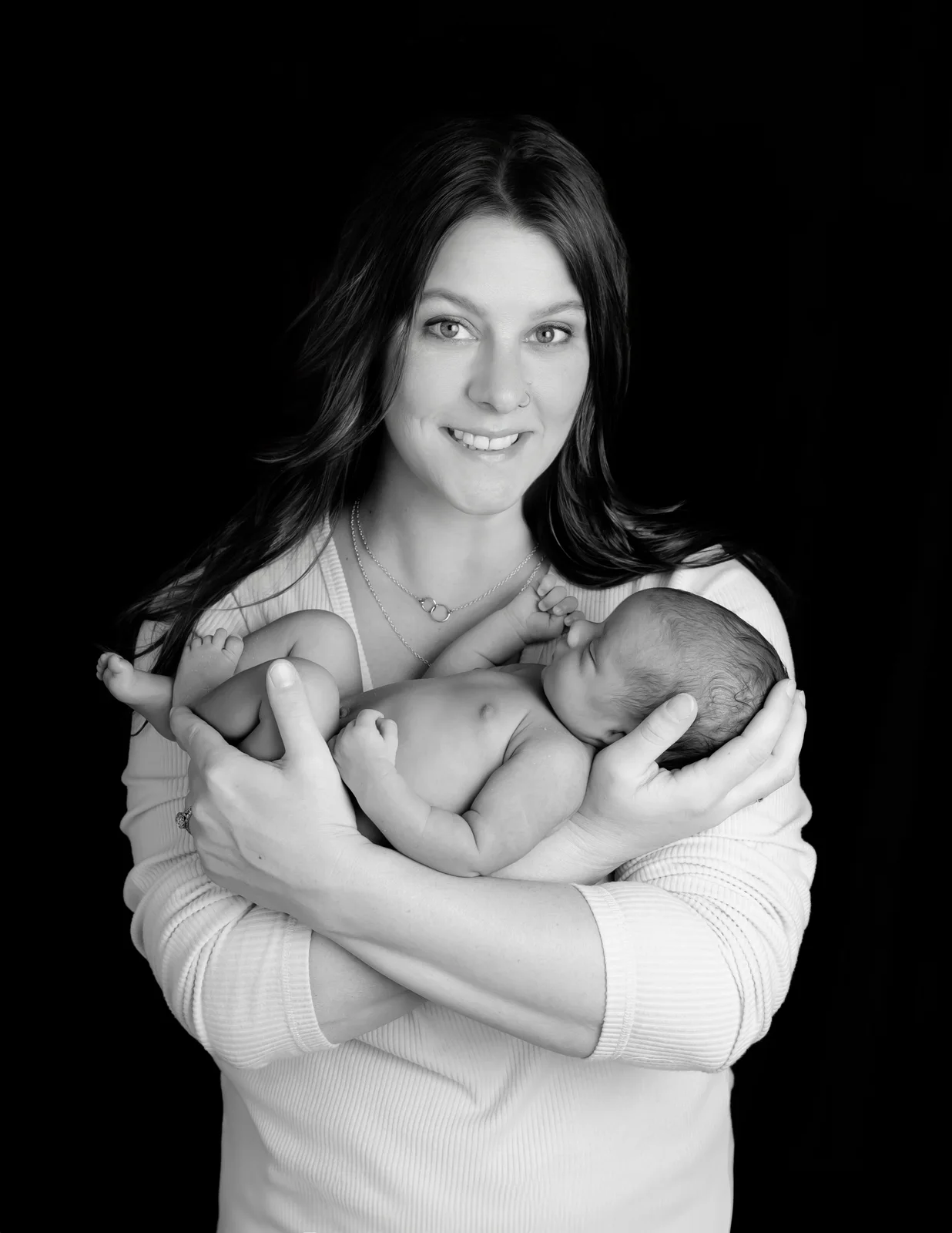 A parent cradling their newborn